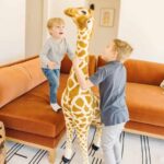Boys Playing with Giant Stuffed Giraffe